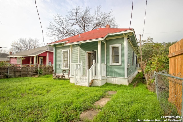 back of house with a lawn