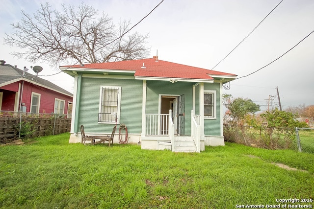 back of house with a lawn