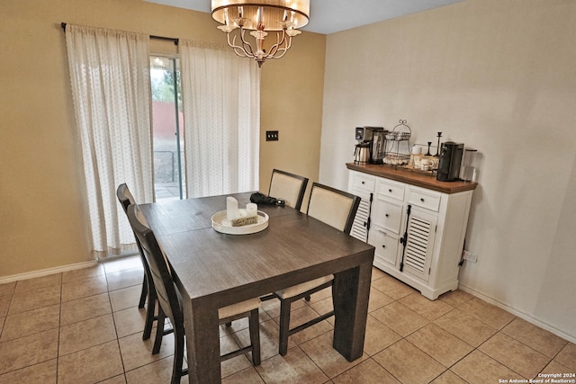 tiled dining room featuring a notable chandelier