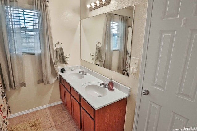 bathroom featuring vanity, a healthy amount of sunlight, and tile patterned floors