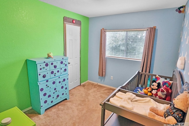 carpeted bedroom with a crib