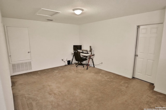 unfurnished room with a textured ceiling and carpet floors