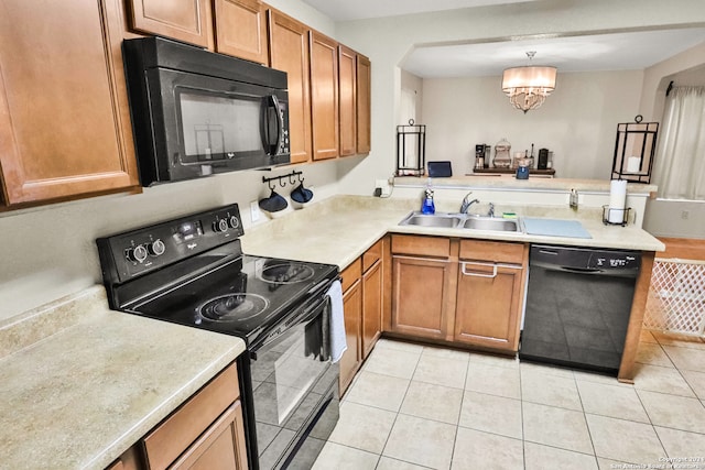 kitchen with light tile patterned floors, an inviting chandelier, sink, and black appliances