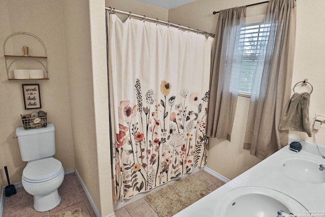 bathroom featuring toilet, a shower with curtain, vanity, and tile patterned floors