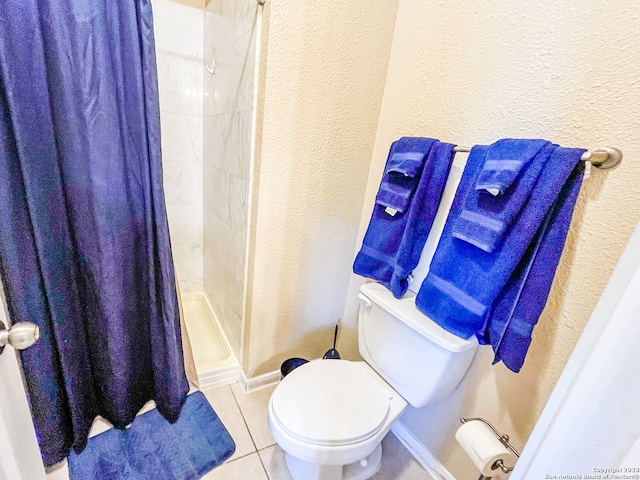 bathroom with a shower with shower curtain, tile patterned floors, and toilet