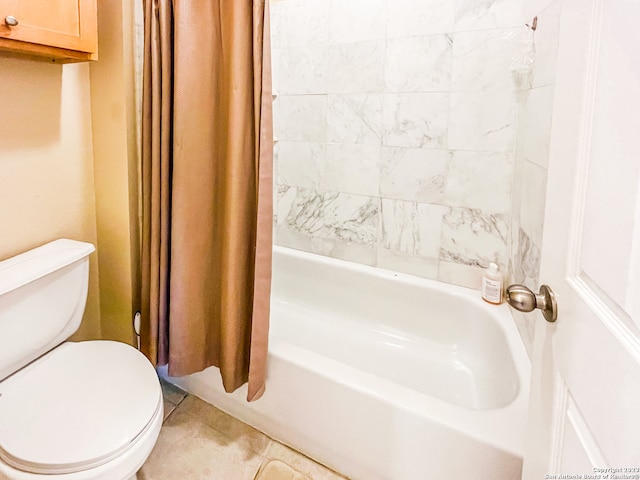 bathroom with tile patterned floors, toilet, and shower / tub combo