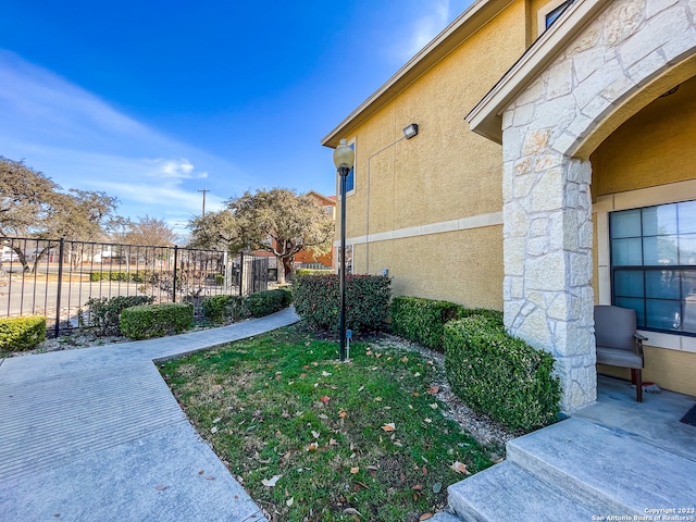 view of side of property with a yard