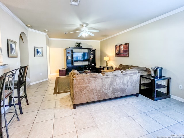 tiled living room with ornamental molding and ceiling fan