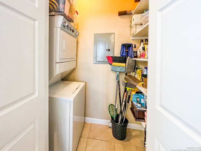 washroom with electric panel, stacked washing maching and dryer, and light tile patterned flooring