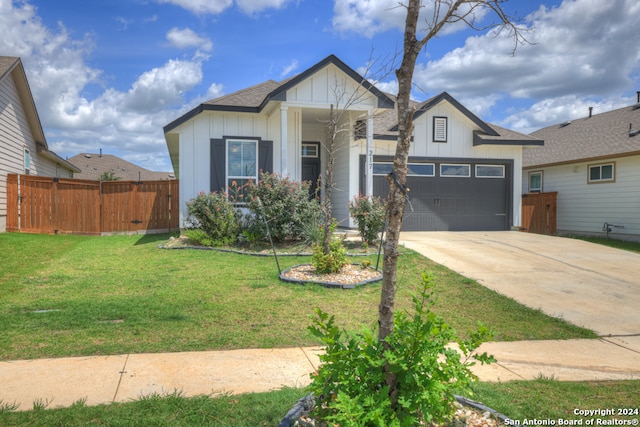 view of front facade with a front yard and a garage