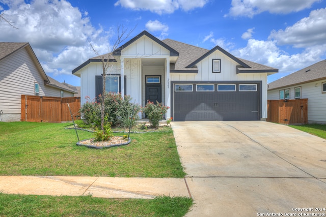 view of front of property featuring a front lawn and a garage