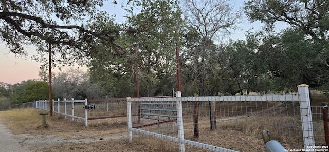 view of gate at dusk