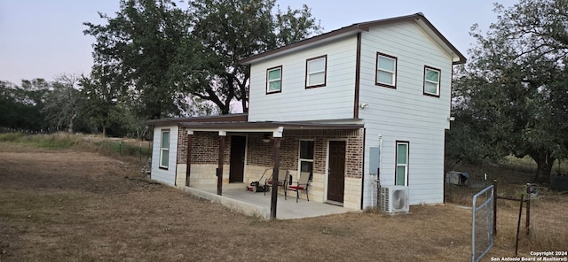 view of front of property with a patio and ac unit