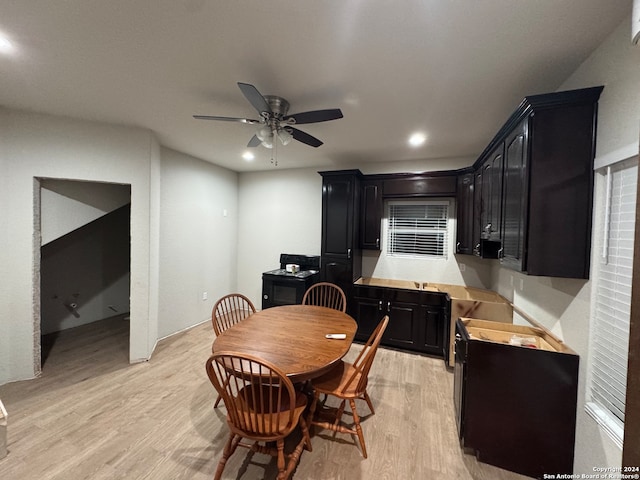 dining area featuring light wood-type flooring and ceiling fan