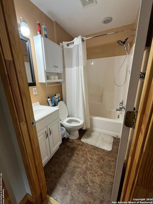 full bathroom featuring shower / bath combo, vanity, and toilet