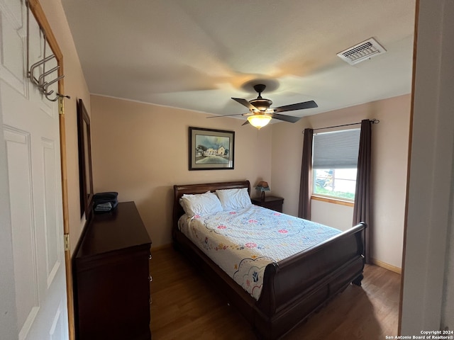 bedroom featuring ceiling fan and dark wood-type flooring