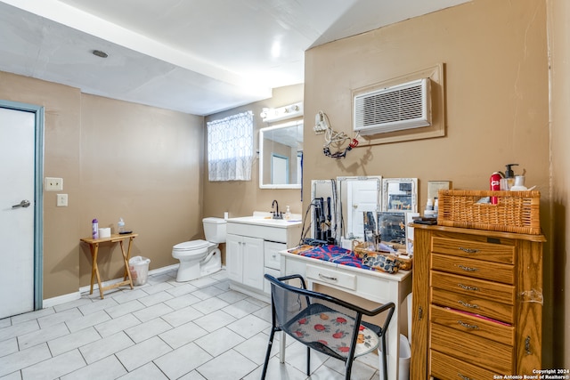 bathroom featuring vanity, toilet, and an AC wall unit