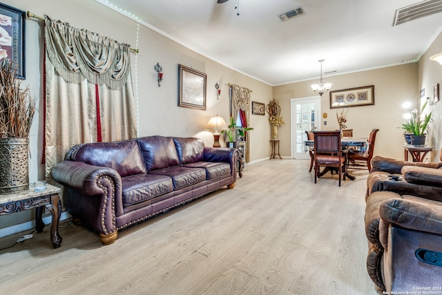 living room featuring ceiling fan with notable chandelier, light hardwood / wood-style flooring, and crown molding