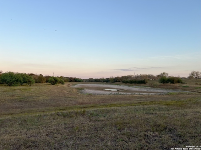 yard at dusk with a rural view