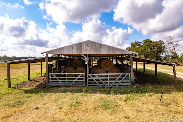 view of horse barn with a rural view