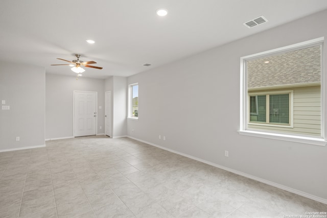 unfurnished room with light tile patterned floors and ceiling fan