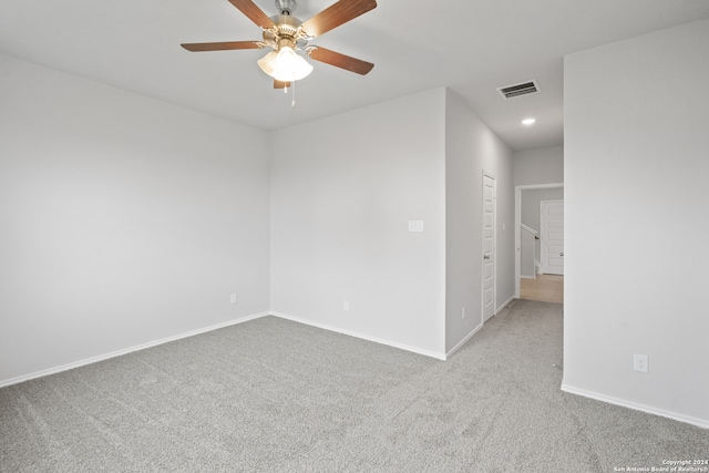 empty room with ceiling fan and light colored carpet