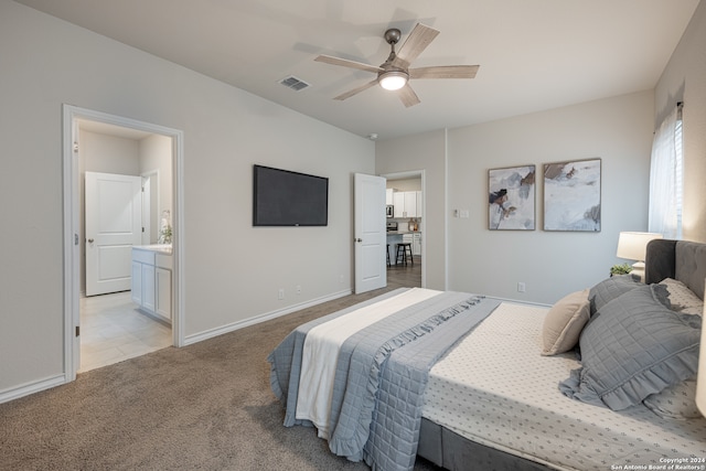 carpeted bedroom with connected bathroom and ceiling fan