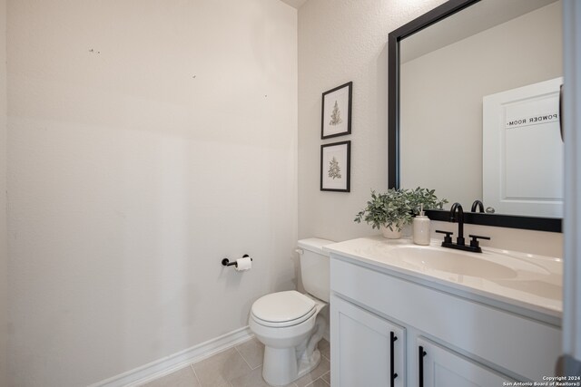 bathroom with tile patterned floors, toilet, and vanity