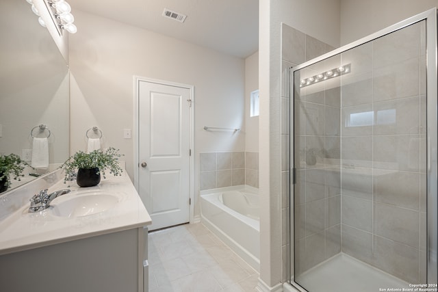 bathroom with plus walk in shower, tile patterned flooring, and vanity