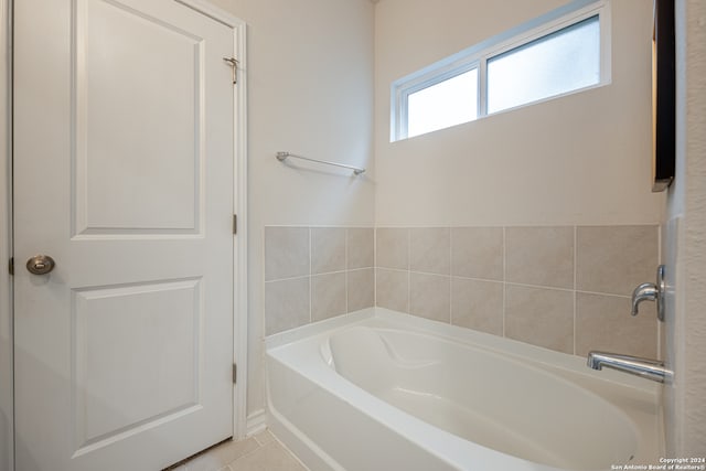 bathroom with a tub and tile patterned flooring