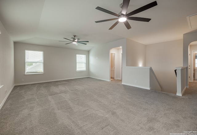 empty room with ceiling fan and light carpet