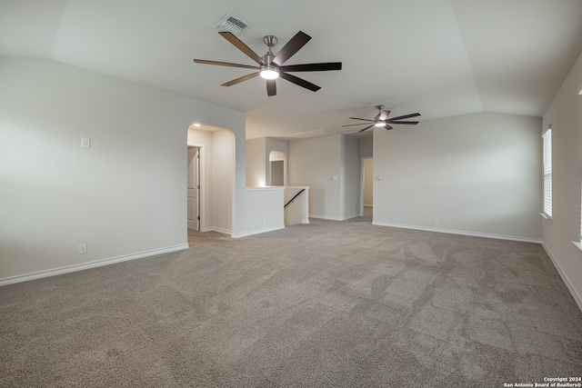 carpeted empty room featuring lofted ceiling