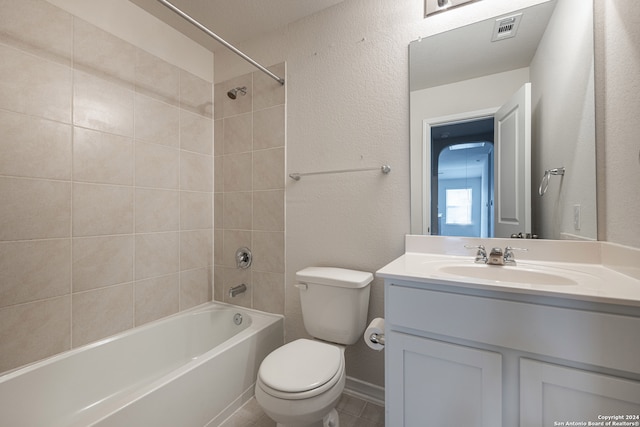 full bathroom with toilet, vanity, and tiled shower / bath