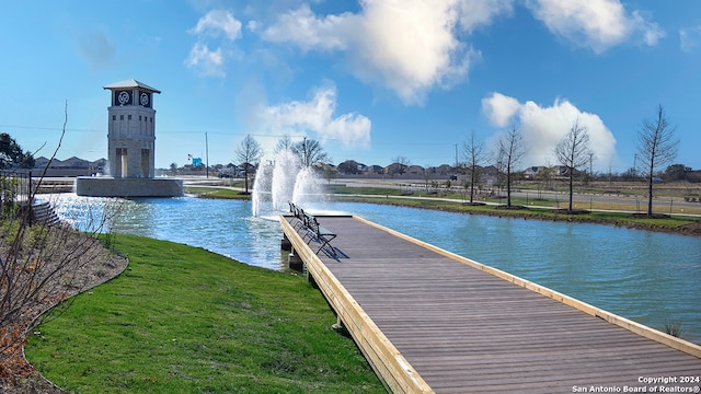 dock area featuring a lawn and a water view