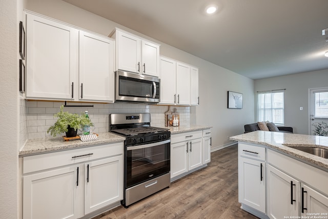 kitchen featuring light stone counters, white cabinetry, and appliances with stainless steel finishes