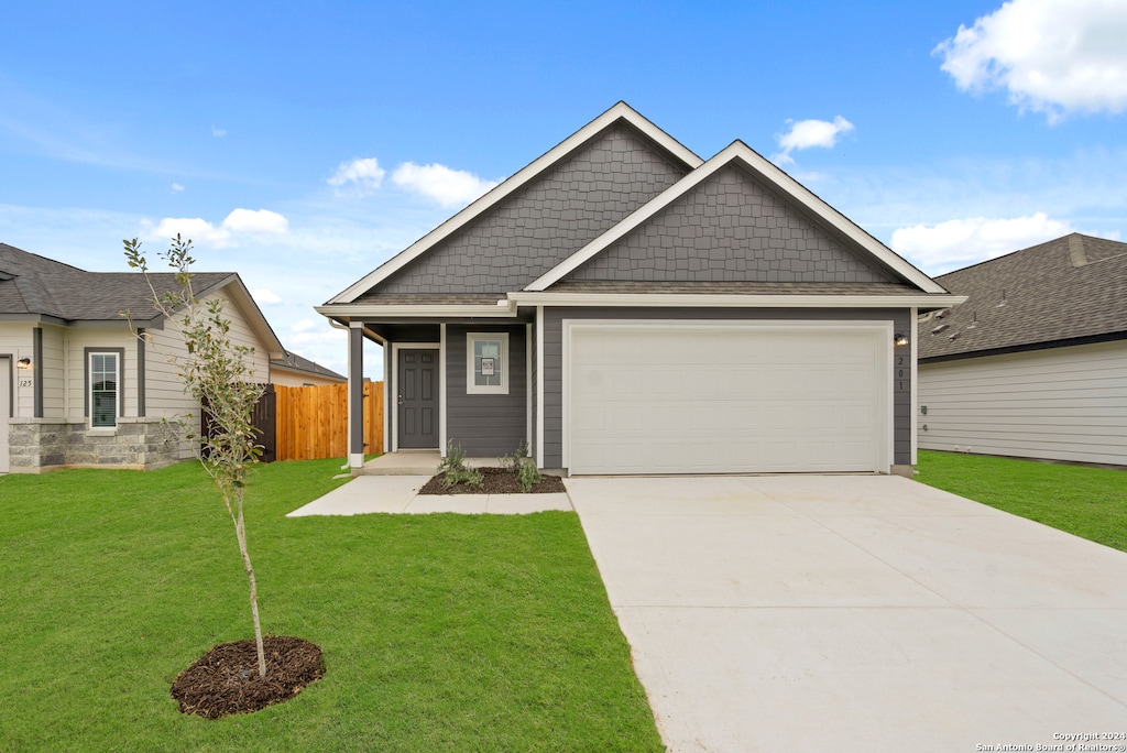 view of front of house with a front lawn and a garage