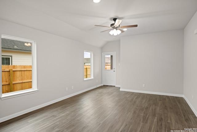 unfurnished room featuring vaulted ceiling, ceiling fan, and dark hardwood / wood-style flooring