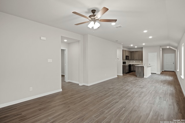 unfurnished living room featuring ceiling fan and dark hardwood / wood-style flooring