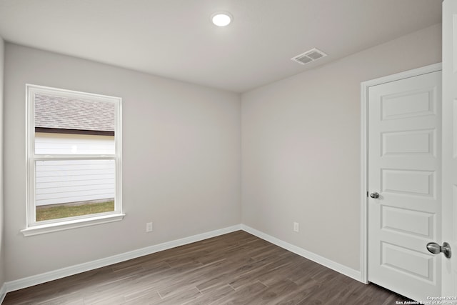 spare room with dark hardwood / wood-style floors