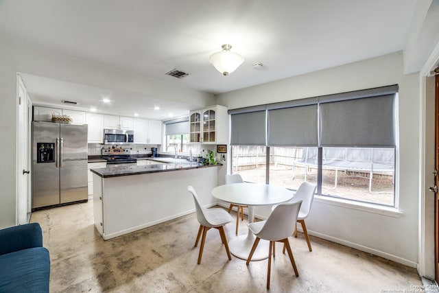 dining room featuring a wealth of natural light and sink