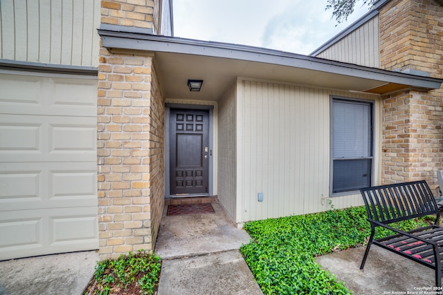 doorway to property featuring a garage