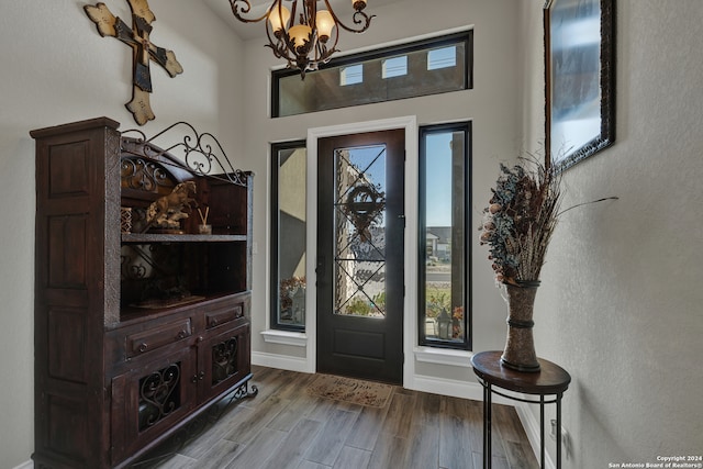 entryway featuring wood-type flooring and an inviting chandelier