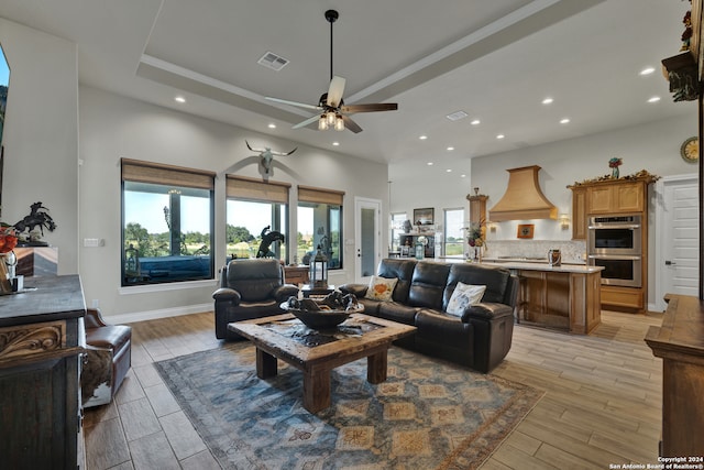 living room featuring light wood-type flooring and ceiling fan