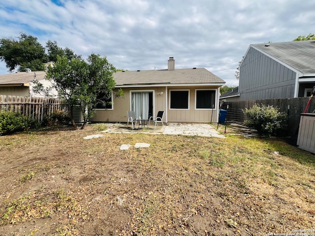 rear view of house featuring a yard