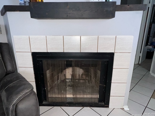 details with tile patterned floors and a tile fireplace