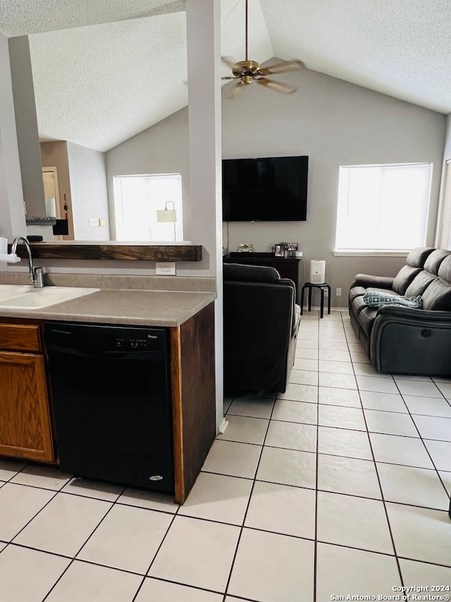 kitchen featuring black dishwasher, lofted ceiling, and a healthy amount of sunlight