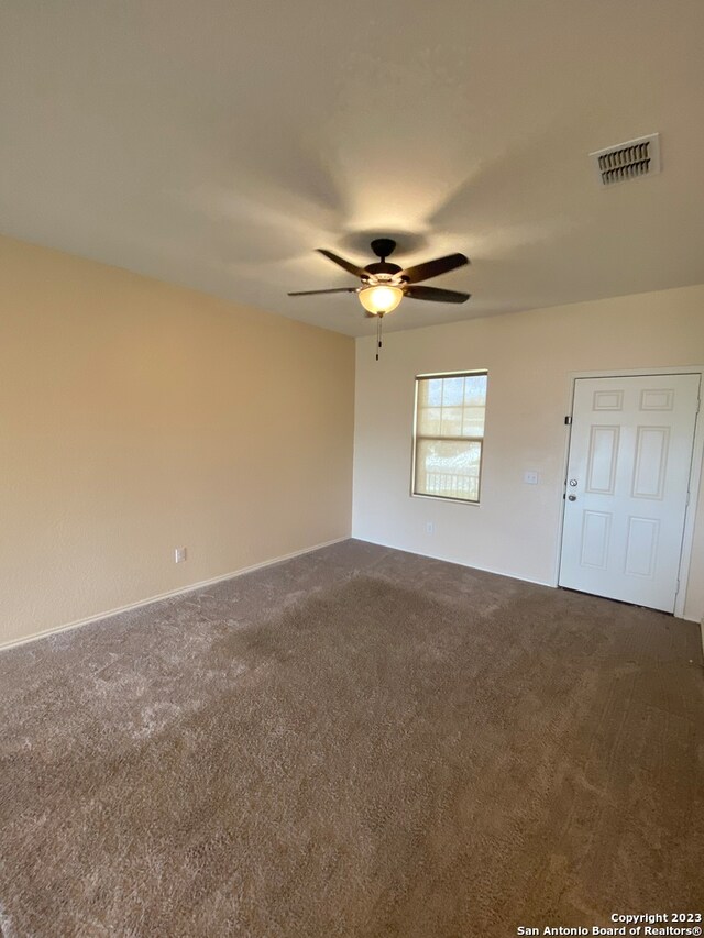 spare room featuring carpet flooring and ceiling fan