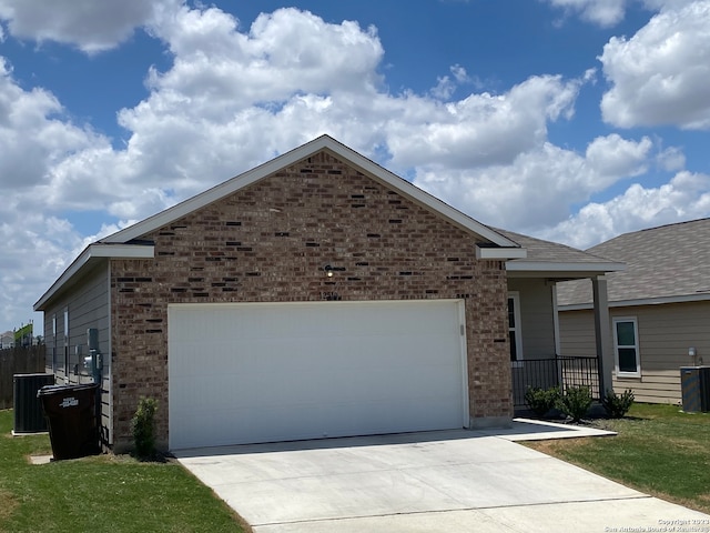 view of front of property with a garage and cooling unit