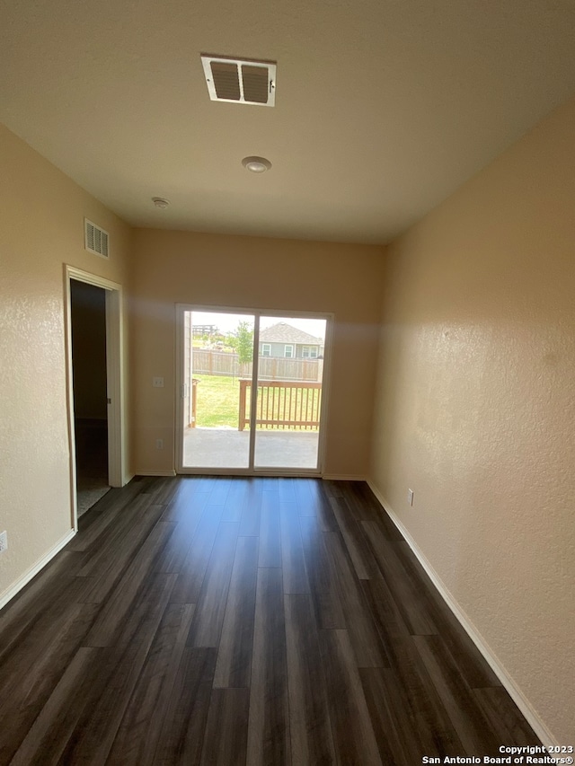 spare room with dark wood-type flooring