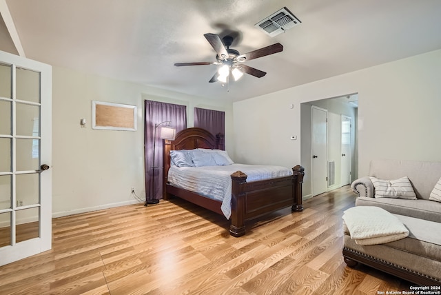 bedroom with light wood-type flooring and ceiling fan